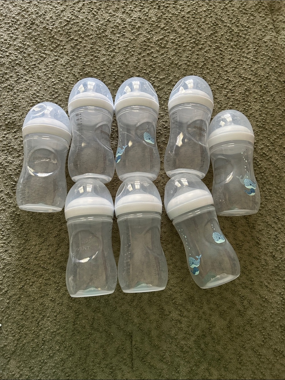 Clear Baby Bottles with White Caps and Light Blue Whale Detail on some.Brand new